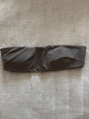 Mörkgrå bandeau bikiniöverdel från Zara - Mycket bra skick!! Bandeau bikiniöverdel från Zara i mörkgrå färg. Rak form och spänne baktill. Materialet är mjukt och stretchigt syntet.