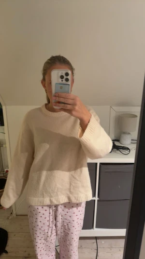 Beige stickad tröja från Gina Tricot - Mysig beige stickad tröja från Gina Tricot i ullblandning. Tröjan har en avslappnad passform, rund halsringning och breda muddar vid ärmslut och nederkant. Perfekt för lager-på-lager under kyliga dagar.