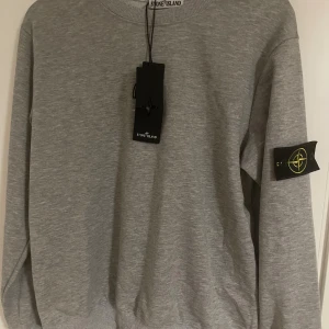 Grå sweatshirt från Stone Island - säljer en tvärget stone island tröja som är helt oanvänd, fick den som present pch vill sälja den då det inte matchar min stil, vid frågor kom gärna Pm😃