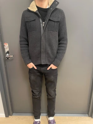 MarcoMörkgrå stickad cardigan jacka - Ny PRIS 2300kr, PRIS GÅR ATT DISKUTERAS NÄR SOM!!! PRISET ÄR INTE HUGGET I EN STEN. (säljs inte längre) Säljer en mörkgrå stickad Cardigan jacka med två stora bröstfickor och dragkedja framtill. Jackan har ribbade muddar, mjukt foder i kragen och en schysst, lite loose passform. Perfekt för kyliga dagar när du vill vara både varm och snygg.