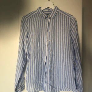 Linneskjorta från GinaTricot - Fin linneskjorta från GinaTricot. Vit och blå randig shorts i 100% linne.