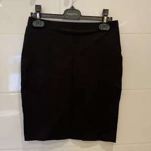 Tight kort kjol  - En svart tight kort skjol i tyg från hm. I storlek xs. Säljer för att jag inte kan ha den längre