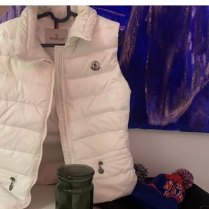 Vit moncler väst  - Intressekoll på min supersnygga moncler väst!  Vit och inga fläckar och så. Passar mig  som har S. Den är vintage och garanterat äkta köpt på vestire. Köp den direkt för 1500 annars bud från 500☺️ hör av er vid frågor. Bud just nu-1300