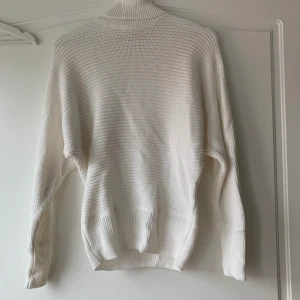 Vit polotröja från NAKD - En fin vit stickad polotröja från NAKD. Den är i storlek s och är aldrig använd så den är i väldigt fint skick. 