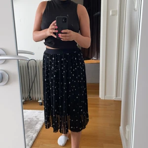 Kjol - En svart kjol med vita prickar från NAKD. Kjolen är aldrig använd och därmed i mycket bra skick. Stoleken är 36 dock är det resor i midjan så passar nog 34-38 ish. 