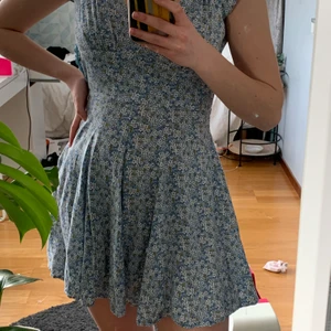 Blå sommarklänning - Säljer denna fina sommarklänning! Den är blå med vita, blåa och gula blommor. Den har två öppningar i ryggen. Den har ett knäppe längst upp i ryggen och även en dragkedja. Jag säljer klänningen då den är för liten för mig. Den har gått lite sönder vid dragkedjan som jag själv har lagat, kan självklart skicka bild på det om du vill:)Om intresset är stort blir det budgivning. Hittar ingen storlek på den men skulle säga att den är 34. Skriv för fler bilder eller om du har frågor🤗