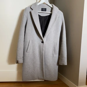 En grå kappa - En grå stilren kappa snygg nu till hösten. Använd ett fåtal gånger.