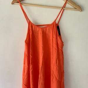 Linne/klänning - Långt linne som även kan användas som klänning om du är kortare än mig (177). Öppen rygg. Storlek XS men det blir väldigt långt om det används som linne. Superfin orange/rosa färg.