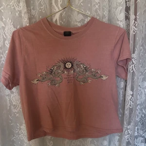 T-shirt från Urban Outfitters  - Rosa kort grafic tee från Urban Outfitters i storlek xs 🧚🏼