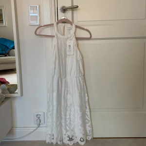 Vit studentklänning - Vit klänning från Vila. Oanvänd, lappen kvar. Köpt för 549kr säljer för 450kr. Perfekt studentklänning🥰 Strl 36. 