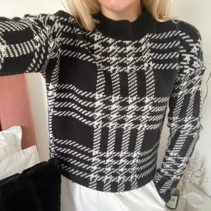 Stickad tröja - Rutmönstrad tröja som sätter sig jättefint på kroppen. Lite högre krage. Köparen står för eventuell frakt