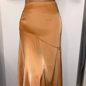 Lång kjol - Lång orange/koppar kjol (golvlång)! I silkes material! Köpt på tise men aldrig använd pga lite för lång!✨Går att hämta eller mötas i Luleå! Även att frakta och där tillkommer en fraktkostnad🤍