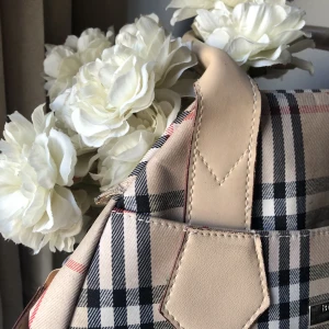 Väska burberry - Galet fin väska (inte äkta).  Men nu är det dags att förnya sig och den förtjänar så mycket mer kärlek än jag ger den nu!   De är en fläck längst ner som jag inte försökt få bort men som trodligtvis går bort.  200kr eller bud!   