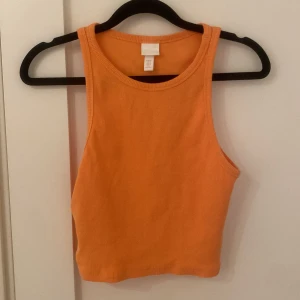 Orange ribbad crop top - Jätte fin topp som är använd 1-2 gånger med jätte fin orange färg från H&M. Storlek M men skulle Säga att den även passar en S.