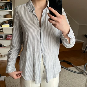 randig skjorta  - trendig randig skjorta, perfekt till vardags eller som beach coverup! tunn och skön, jättefina ljusblå ränder.