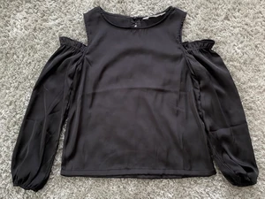 Satin tröja/topp från H&M i strl.158 - Svart satin topp med öppning på axlarna. Använt väldigt få gånger. Finns inte längre att köpa i ordinarie butik!