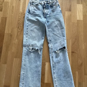 Slitna jeans strl xs - Jag säljer dessa blåa slitna jeans i storlek xs. Jeansen har hål vid knäna och sitter som en xs, strl 24. 