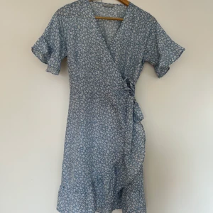 Klänning  - En ljusblå klänning med vita blommor på💞 Köparen står för frakten💞