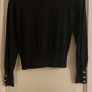 Svart tröja med guldknappar  - fin höst tröja med guldknappar i bra skick! 