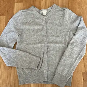 Light knitted gray cardigan