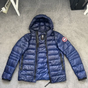 Canada Goose hooded jacket  - Canada Goose hooded down jacket  Storlek S P (small herr) Köpt på Saks Fith Ave Kvitto, tags, kasse, straps följer med (nypris 9000kr) Jag kan mötas upp i Stockholms området eller shippa 