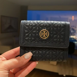 Tory Burch  - A brand new navy Tory Burch wallet which is a set of my other ad bag (purse). I bought it from the US for 230 USD. 