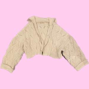 En croppad stickad tröja från Pull&Bear. Tjock o skön, krämvit färg. Oversize.