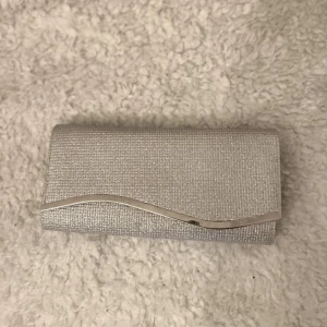 Silvrig clutch - Superfin silvrig clutch, perfekt för balen!! I felfritt skick, endast använd en gång!