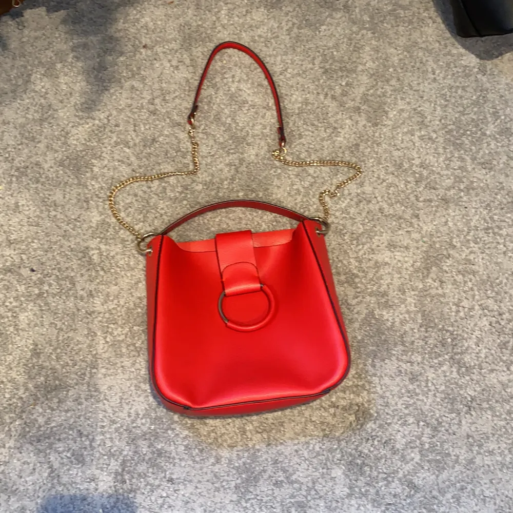 Röd handväska i väldigt fint skick. Mellan stor storlek och säljs pågrund av att den inte kom till användning. Frakt ingår inte i priset. Priset är diskuterbart.. Väskor.