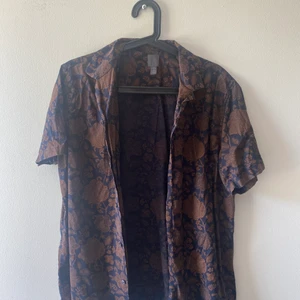 Brun kortärmad skjorta - En superfin brun kortärmad skjorta från HM! Passar perfekt nu till sommaren. Önskas fler bilder på passform osv så är det bara att höra av sig! Köparen står för frakt.