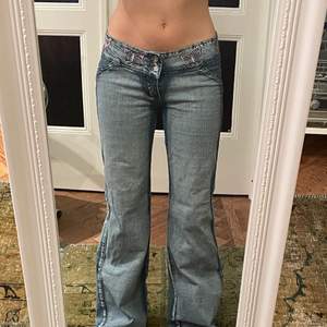 Ett par snygga jeans som bara inte kommer till användning. Använt väldigt fåtal gånger och ser ut och känns som helt nya. Jeansen har dubbla knappar och coola fjärils detaljer uppe vid midjan.