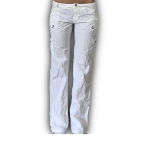 Vita 00s yk2 Cragopants - Supersnygga vita cargobyxor som passar s-m men jätte snygga med ett bälte tex om man har mindre storlek.  Lågmidjade och flare cut, strl 40 men som sagt super söta med bälte eller snöre.  Midja-89/90cm innerbensmått- 79cm 