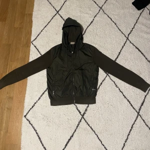 Moncler cardigan-Mörkgrön - Säljer min riktigt snygga Moncler cardigan till bra pris! Köpt på NK för 6999 kr. Lite tyg har gått upp på armen men inget man märker