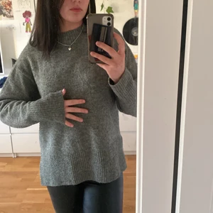 Grå stickad tröja från hm - Mysig grå tröja från hm, sticker inte alls och är ganska lång både på längden och i ärmarna. Säljer pga används inte längre. På tredje bilden syns ett litet hål, inga andra skador. Köparen står för frakten<3