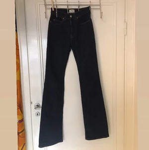 Acne jeans bootcut - Oanvända jeans från Acne i en modell som inte längre säljs. Supersmickrande passform! Långa i benen (säljer pga är för kort) och midjan slutar strax under naveln. Snygg indigoblå färg med gula sömmar. 