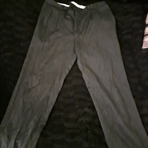 Svarta kostymbyxor - Nice kostymbyxor men lite randigt material, passar inte dem längre men dem är köpta second hand så dem är nice, men lite använda. Är lite osäker på storleken men min gissning hade varit 42 eller 44. Hade jag passat dem hade jag tagit bättre bilder