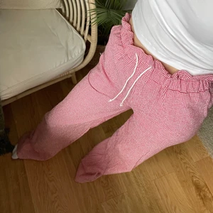 Rödrutiga byxor  - Ett par röda & vita rutiga linnebyxor i en rak modell! Jag har sytt dem själv (tyget är från selfmade). Jag säljer dessa otroligt snygga, trendiga och sköna byxor då jag inte kände att modellen passade min kroppstyp. Jag skulle säga att storleken är XS/S då det är storleken jag oftast har!