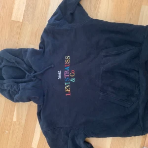 Levis hoodie - Säljer en svart Levis hoodie med regnbågslogga. Sitter lite oversized. 