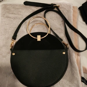 Väska - Snygg svart väska med guld.