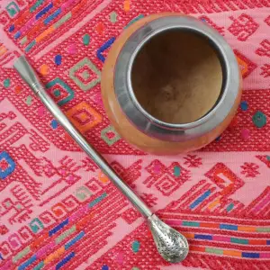 The maté gourd was originally from the Guarani people of South America. It is made from a calabash squash, which varies in shape and has a hard shell. Maté tea is half filled into the gourd with hot water through a metal straw Bombilla HandMade in Uruguay