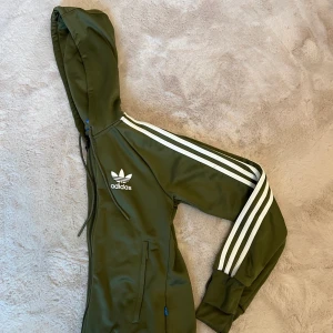 Adidas jacka  - Olivgrön Adidasjacka i XS. Dam.  Som ny!