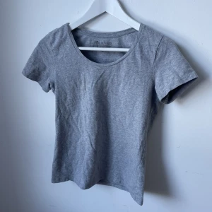 T-shirt - Basic grå t-shirt med lite kortare ärmar, skön och mjuk att bära! Passar till allt! Står storlek M men skulle säga att den är mindre i modellen!
