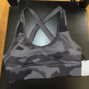 Sport-bh  - Nyskick, helt oanvänd då den är lite liten i storlek. Väldigt bekväm och skönt tyg måste jag säga! Har exakt denna modell men i annan storlek och färg :)  Den är även justerbar samt har korsad rygg! Skulle säga att den är som en S storleksmässigt. 