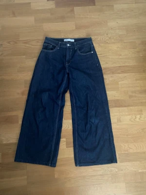 Mörkblå wide leg jeans! - Fina, mörkblå jeans från Bershka med vida ben i strl 38/M💞 skulle säga att de är midrise  Midja(tvärs över): 38cm, innerbenslängd:71 cm
