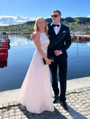 Rosa balklänning - Elegant rosa långklänning i satin med hög slits och ärmlös design. Klänningen har en stilren, figurnära passform och rund halsringning. Perfekt för speciella tillfällen när du vill känna dig extra fin.