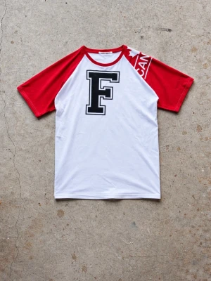 Upcycled raglan t-shirt - Upcycled raglan tee we’ve sewn, combining two vintage graphic tees. Boxy fit and in great condition, 100% cotton.