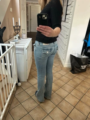 Ljusblå bootcut jeans från True Religion - Säljer ett par ljusblå bootcut jeans från True Religion i modellen Joey, Low Rise flare. Dom har slitningar nere vid hälen. Hör av dig för mer bilder eller info💕