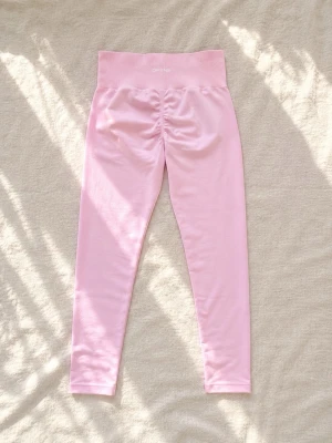 Ljusrosa seamless leggings från DFYNE - Supersnygga ljusrosa leggings från DFYNE med hög midja och seamless design. De har scrunch-detalj bak för extra form och är gjorda i ett stretchigt, mjukt material som sitter skönt hela dagen. Perfekta för en trendig och bekväm look. Kvitto finns vid förfrågan 