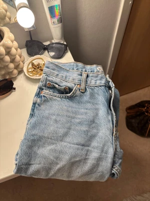 Ljusblå jeans från Gina tricot perfect jeans - Säljer ett par ljusblå jeans från Gina tricot, perfect jeans, i klassisk femficksmodell. Jeansen har raka ben och snygga kontrastsömmar. Perfekta till vardags och lätta att styla med olika toppar och sneakers.🤍