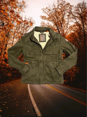 Superdry Rookie Field Jacket - Snygg Superdry ”The Rookie” Field Jacket i khaki/mörkgrön färg💯🍾 Perfekt höst eller vår jacka som passar med det mesta! Jackan är i mycket bra skick, säljer då den inte passar mig längre. Herr modell Storlek : S  Längd: 65cm Bredd: 46-47cm Armlängd: 65cm